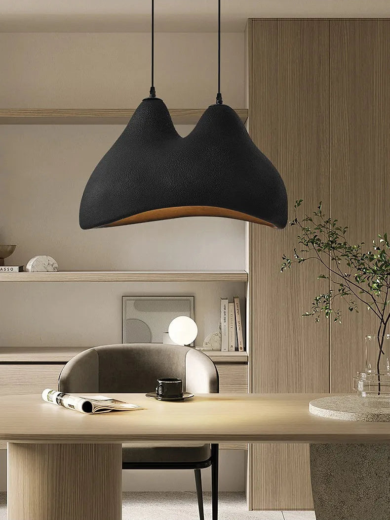 Domus Collective Sand Dunes Pendant Light in black, suspended above a Japandi-style workspace with timber shelving, a soulful statement piece where desert-inspired sculpture meets refined everyday living.