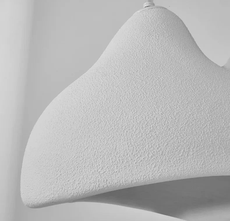Detail shot of the Domus Collective Sand Dunes Pendant Light in white, the undulating twin-peak silhouette rendered in deeply textured resin, evoking the quiet beauty of wind-shaped dunes.