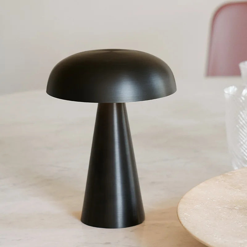 Shroom Aura Portable Lamp in brushed black metal finish with refined mushroom dome cap, offering understated sophistication for modern tabletop styling by Domus Collective.