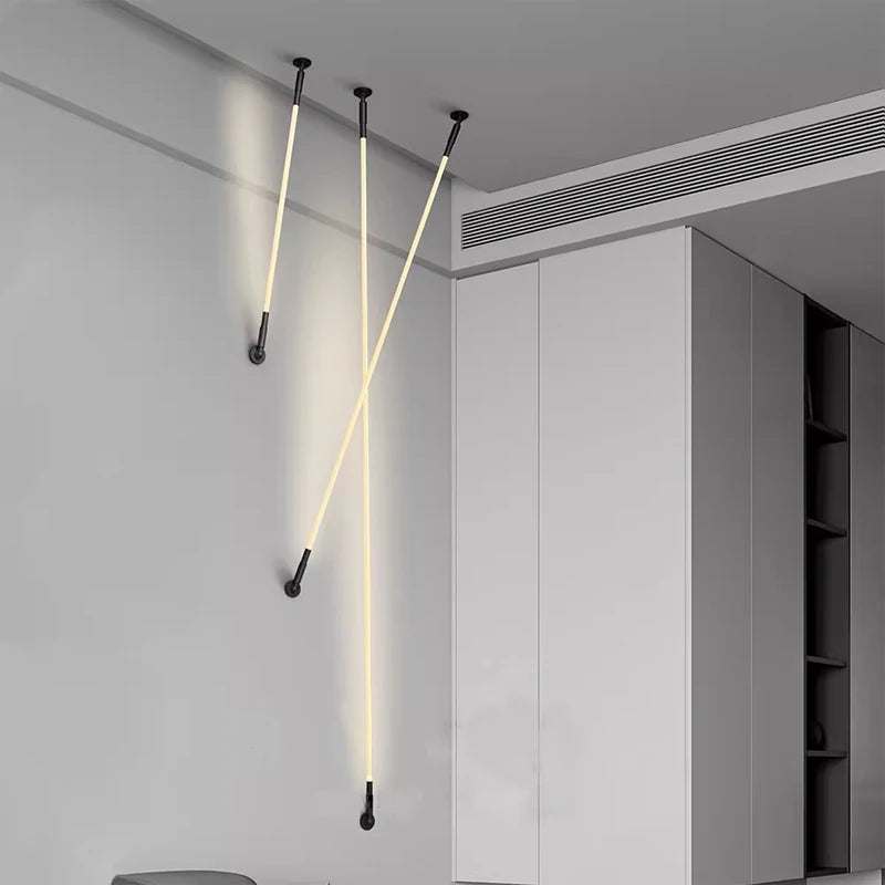 Spectra Flex Wall Lights installed in a crossed arrangement spanning from ceiling to wall, their warm luminous glow and adjustable positioning adding geometric drama to modern living spaces, by Domus Collective.