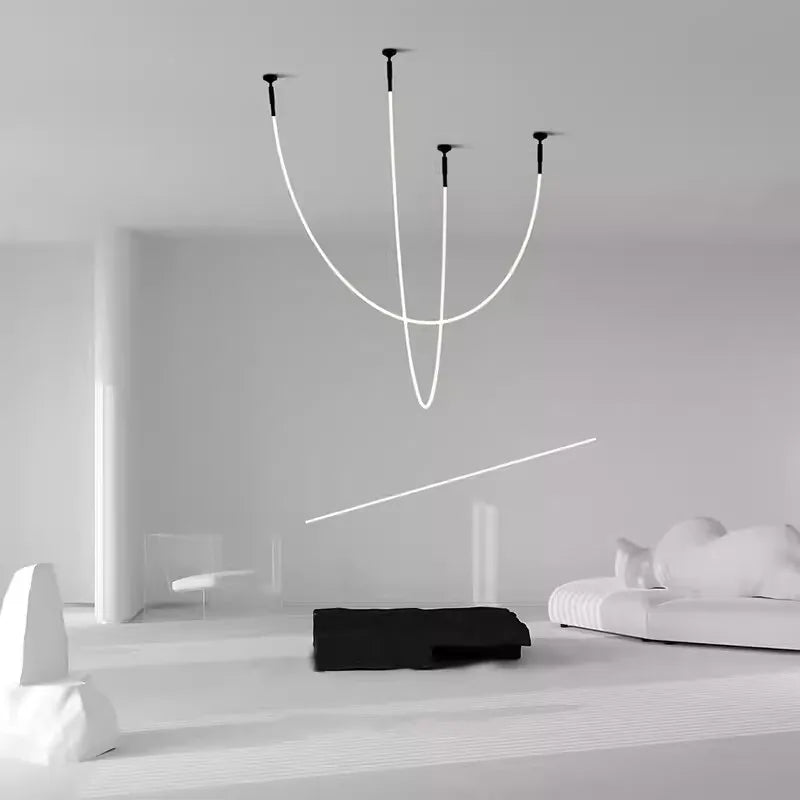 Spectra Flex Wall Lights configured as a ceiling-mounted installation with gracefully curved LED tubes forming an artistic chandelier alternative in a monochromatic minimalist interior, by Domus Collective.