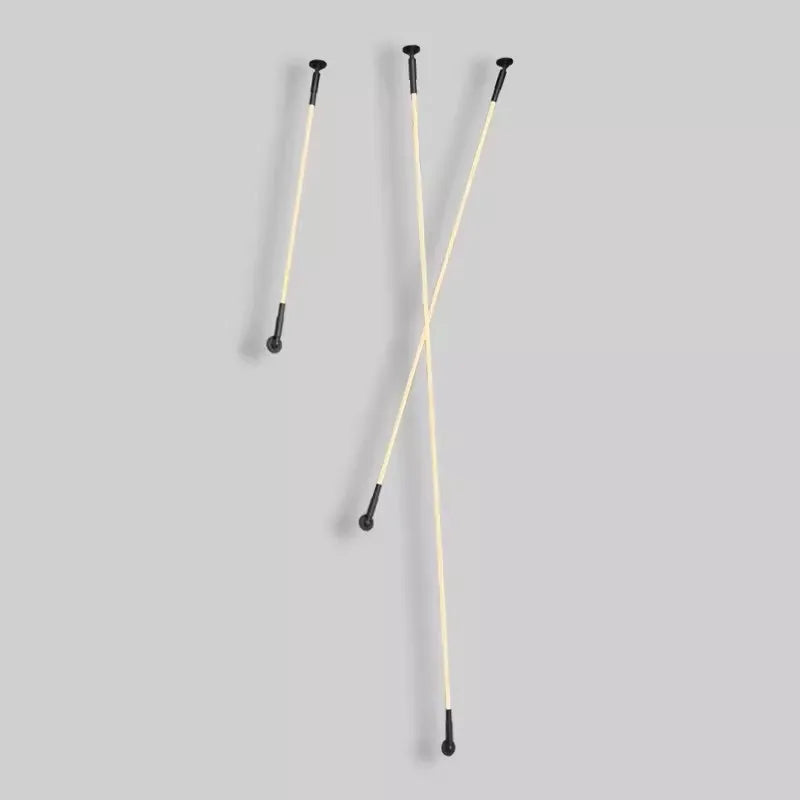 Three Spectra Flex Wall Lights displayed against a grey background showing the versatile bendable LED tubes with matte black ball-joint mounts, demonstrating adaptable positioning for creative wall installations.