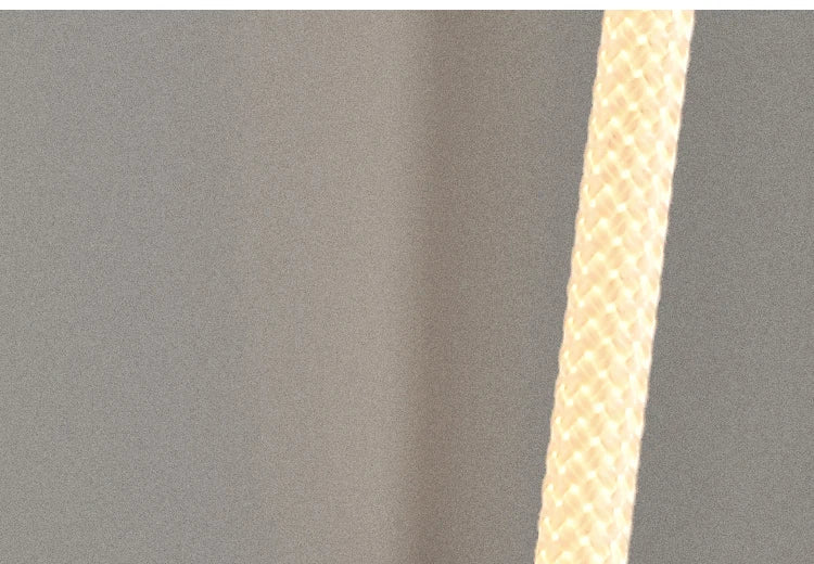 close-up detail of the Spectra Flex Wall Light's textured woven LED tube emitting soft warm illumination, highlighting the quality construction and diffused glow of the bendable light element.