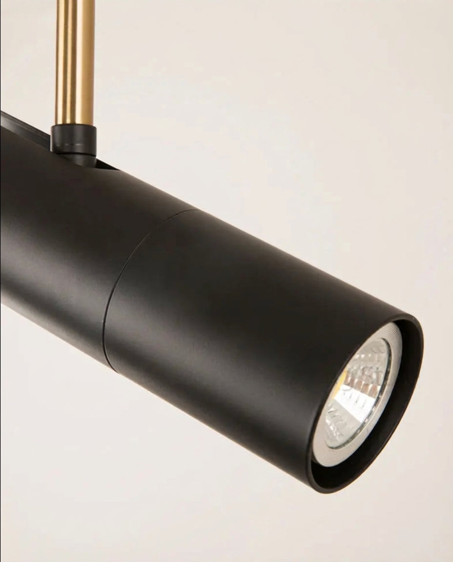 Close-up of the Domus Collective Spotlight Pendant Light in black-gold, showcasing the adjustable cylindrical head and precision lens,meticulous detail for discerning Australian interiors.