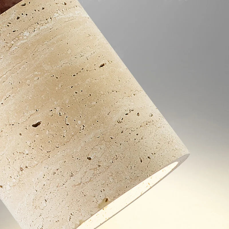 Close detail of the Stone Cylinder Pendant Lamp revealing natural travertine texture with characteristic pitting and organic veining for authentic material beauty, by Domus Collective.