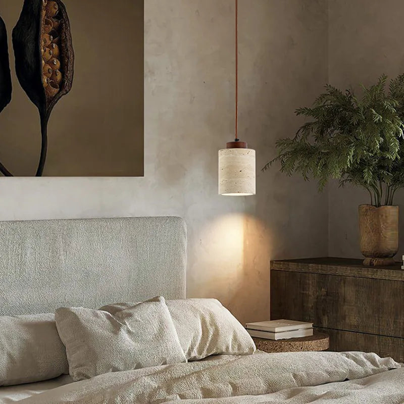 Earthy tall walnut,elegance from the Stone Cylinder Pendant Lamp, its cream travertine shade and walnut wood cap bringing grounded warmth to a textured contemporary bedroom, by Domus Collective.