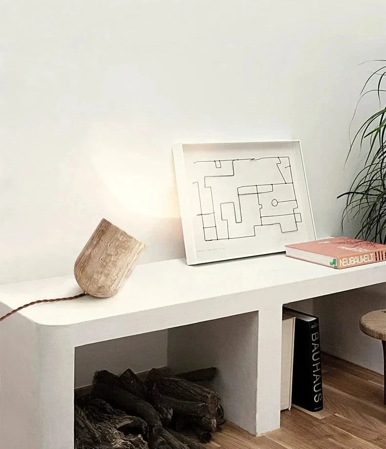 Organic sophistication meets architectural balance in the Stone Spotlight Table Lamp, solid travertine construction delivering focused illumination on a minimalist console, by Domus Collective.