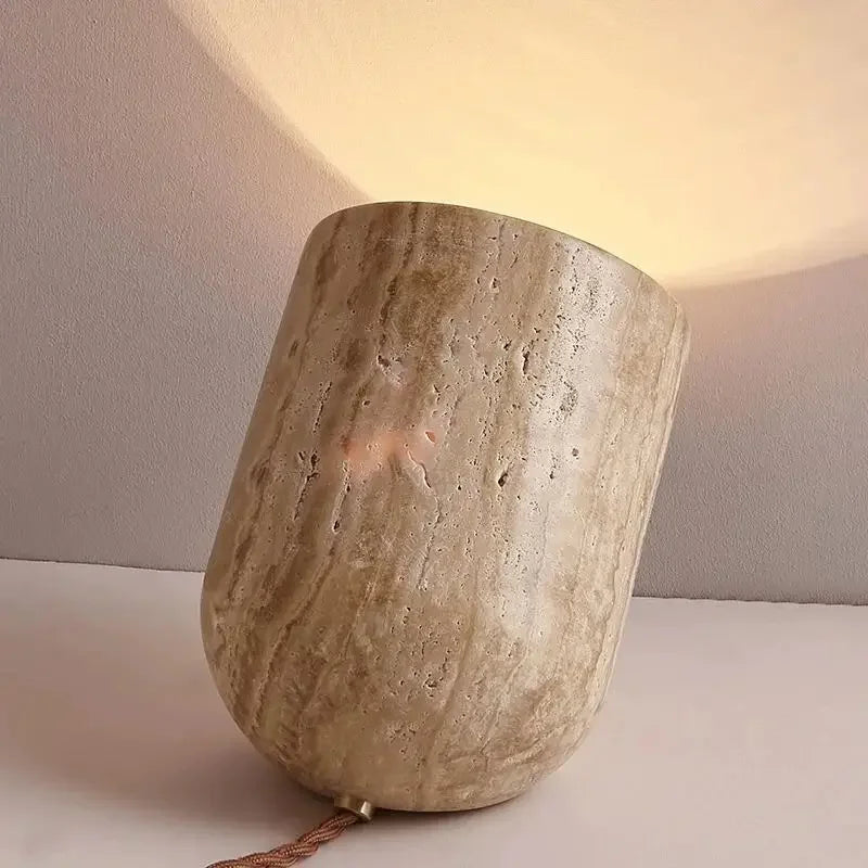 Rear view of the Stone Spotlight Table Lamp showcasing organic stone veining and rounded silhouette, warm light projection creating atmospheric wall wash, by Domus Collective.