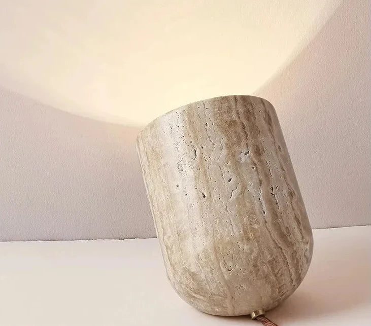Pale travertine Stone Spotlight Table Lamp with natural striations and subtle pitting, angled form projecting warm directional light for reading nooks and bedside tables, by Domus Collective.