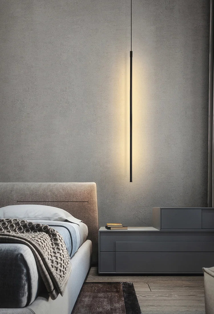 Slender black vertical form creating warm refined atmosphere as bedside lighting in a sophisticated contemporary Australian bedroom ,the Streamline Shine Suspension Light,by Domus Collective Steel the Show collection.