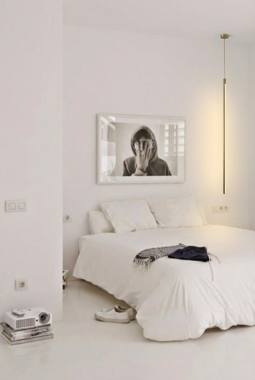 Streamline Shine Suspension Light in brass casting soft ambient glow beside monochrome art in a pristine minimalist Australian bedroom,by Domus Collective curated collection.