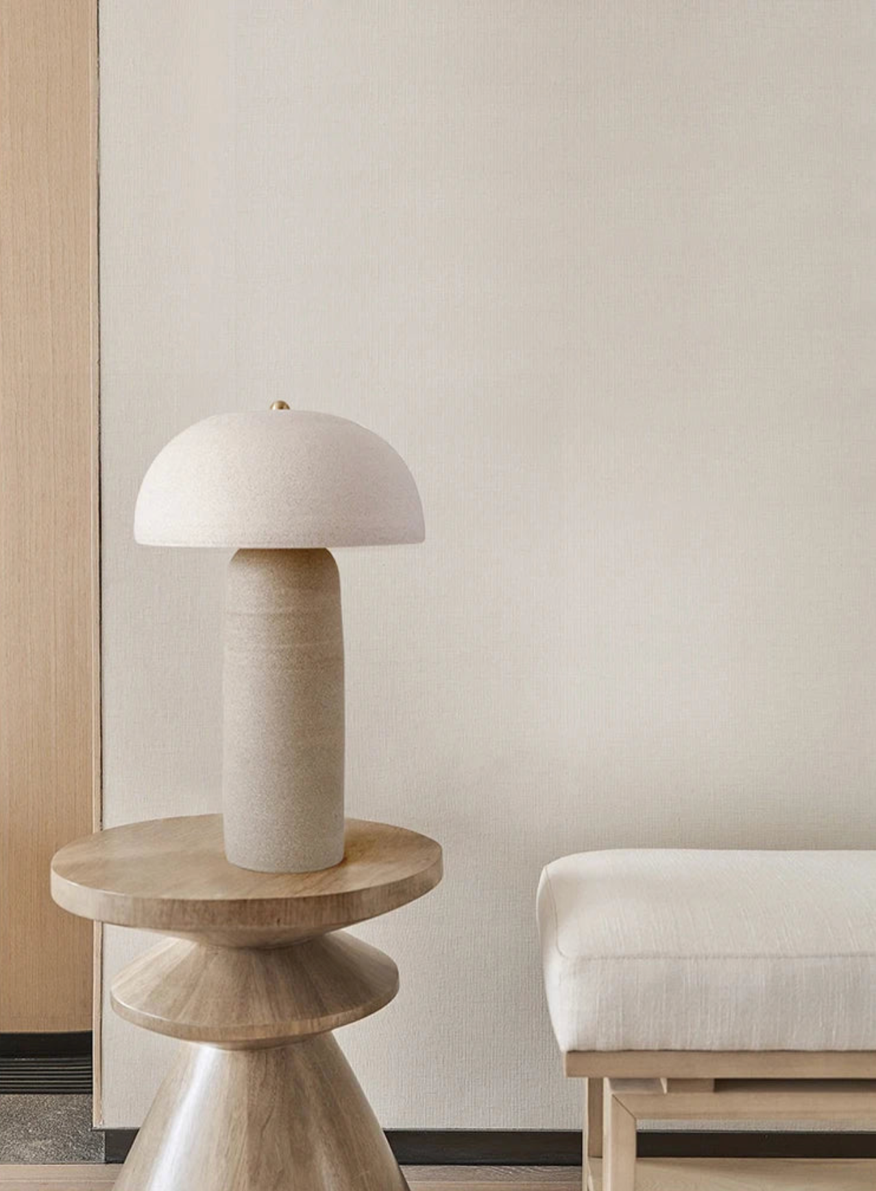 Handcrafted Terra Mushroom Table Lamp featuring textured sand-coloured ceramic construction, mushroom-inspired silhouette with tiltable shade on a sculptural wooden side table, by Domus Collective.