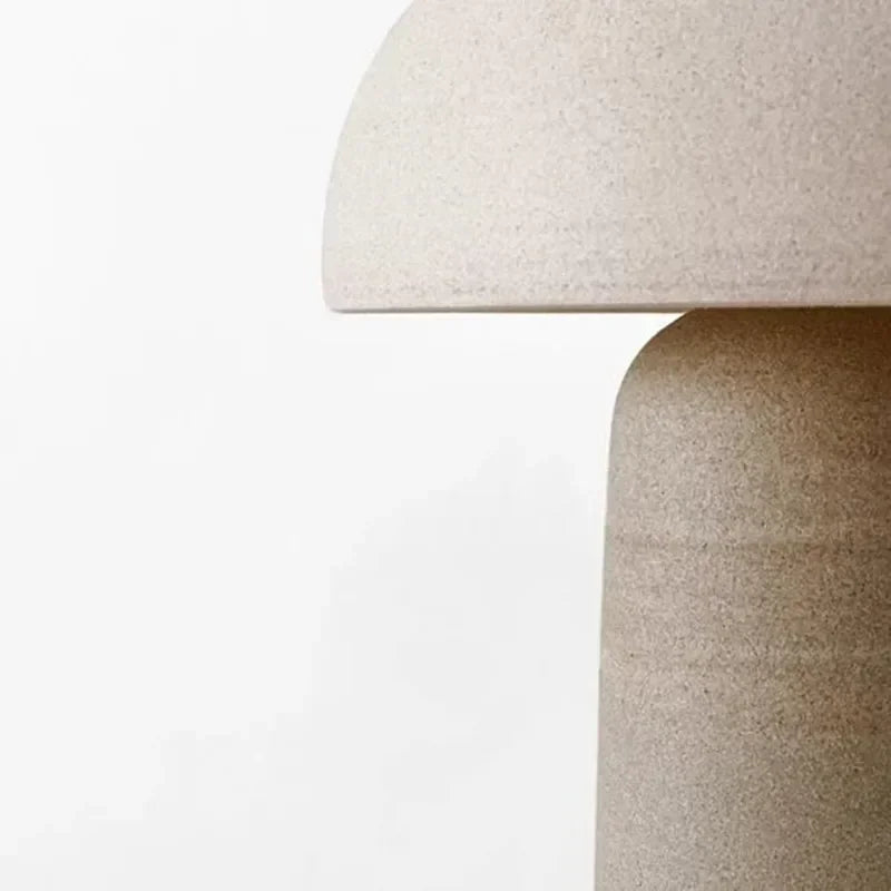 Close-up texture detail of the Terra Mushroom Table Lamp revealing speckled ceramic surface and precise joinery between dome shade and cylindrical stem, by Domus Collective.