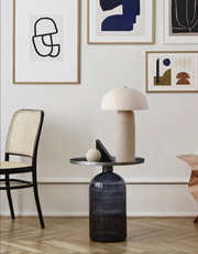 Terra Mushroom Table Lamp in natural cream ceramic with organic dome shade and cylindrical base, sculptural earthy elegance displayed in a curated gallery-style living room, by Domus Collective.