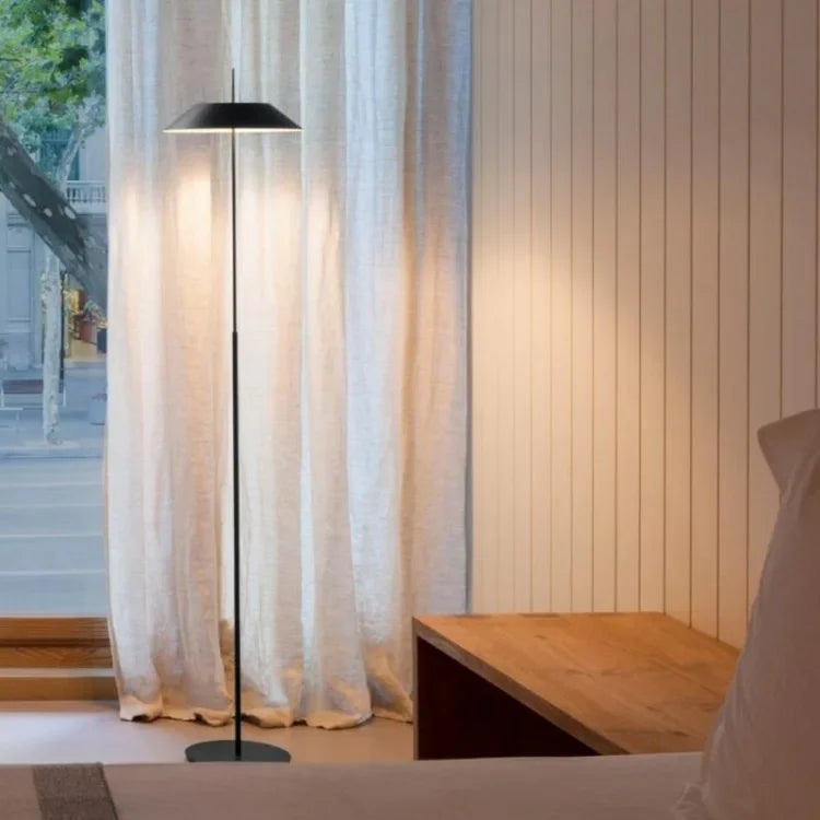 Matte black Toothpick Balance Floor Lamp with conical metal shade, sleek minimalist design bringing soft ambient glow to modern bedrooms and reading nooks, by Domus Collective.