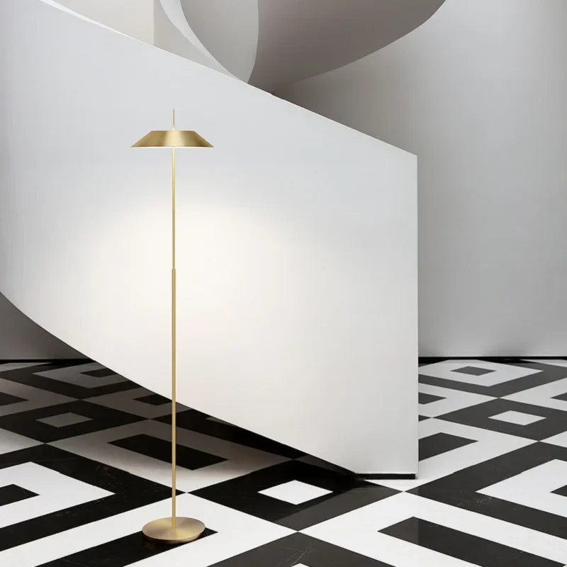 Toothpick Balance Floor Lamp in brushed brass finish, minimalist sculptural lighting with a slender stem and conical shade delivering soft ambient glow, by Domus Collective.