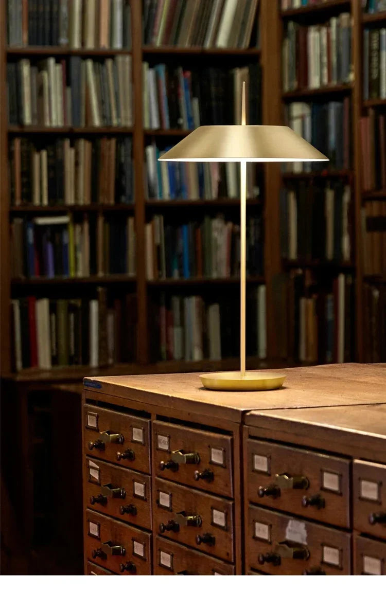 Gold Toothpick Balance Table Lamp illuminating a vintage library card catalog in a traditional book-lined study, blending modern design with classic interiors by Domus Collective.