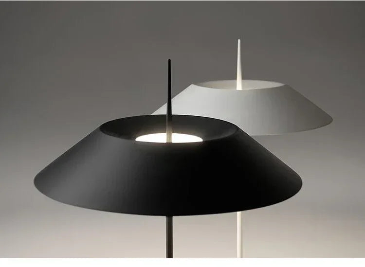 Close-up of Toothpick Balance Table Lamp shades in matte black and white revealing the distinctive needle-thin finial and wide conical form, precision engineered by Domus Collective.