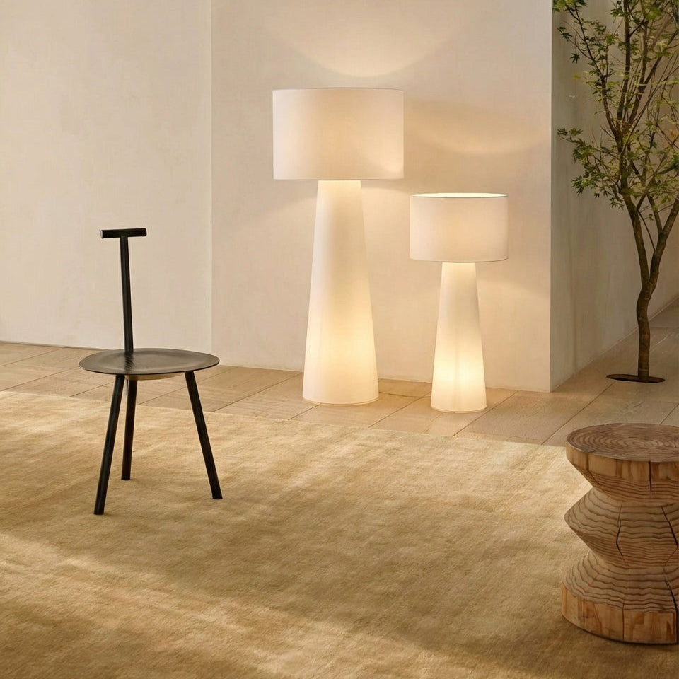 Modern stylish interior with 2 Tower Glow Floor Lamp lamps in a room with a chair and decorative plant  from Domus Collective