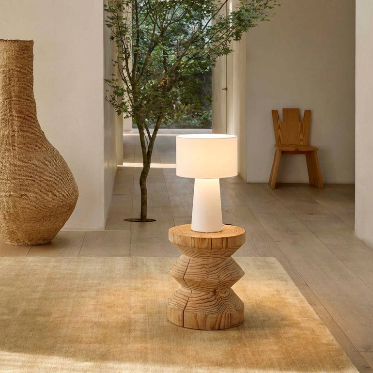 Modern interior with a tall woven vase, wooden table, and  with a Tower Glow Floor Lamp from Domus Collective.