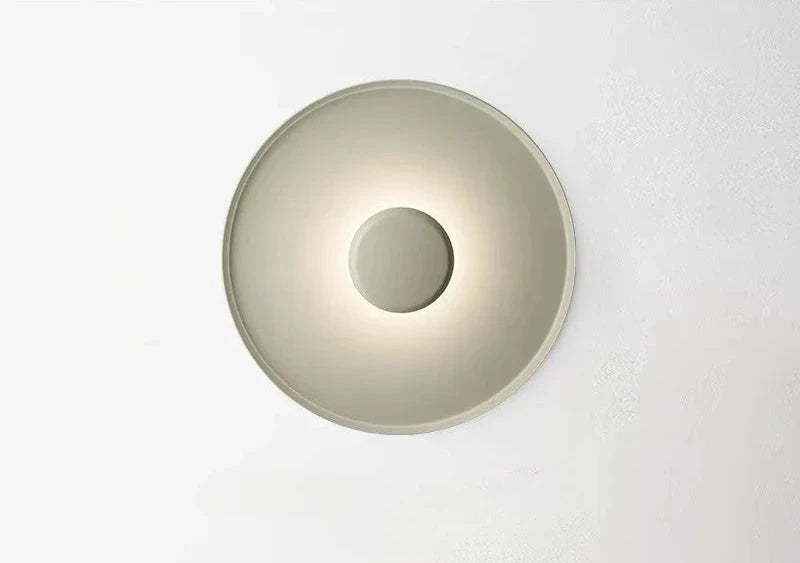 Domus Collective UFO Wall Lighting in green with distinctive concave form and central detail creating characterful ambient lighting ,a minimalist statement piece for elevated Australian living.
