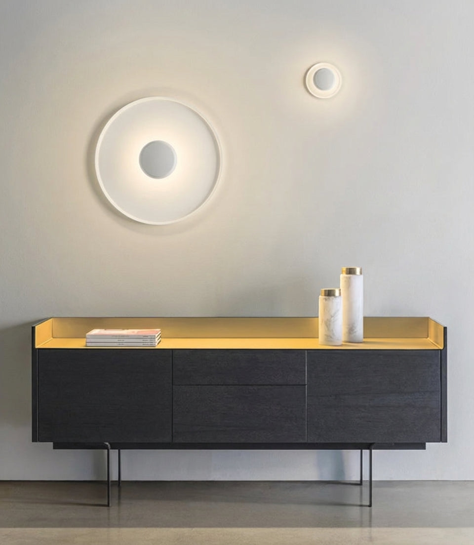 UFO Wall Lighting in white shown in two sizes above a modern sideboard, demonstrating layered lighting possibilities with warm soft illumination,from Domus Collective curated wall lights collection.
