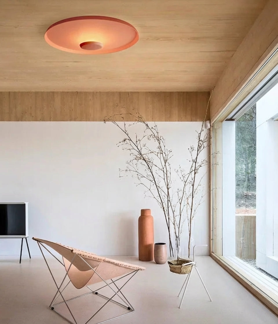 Domus Collective UFO Wall Lighting in warm red bringing soulful colour to a light-filled Scandinavian-inspired living space, sculptural ceiling light transforming interiors with distinctive warmth.
