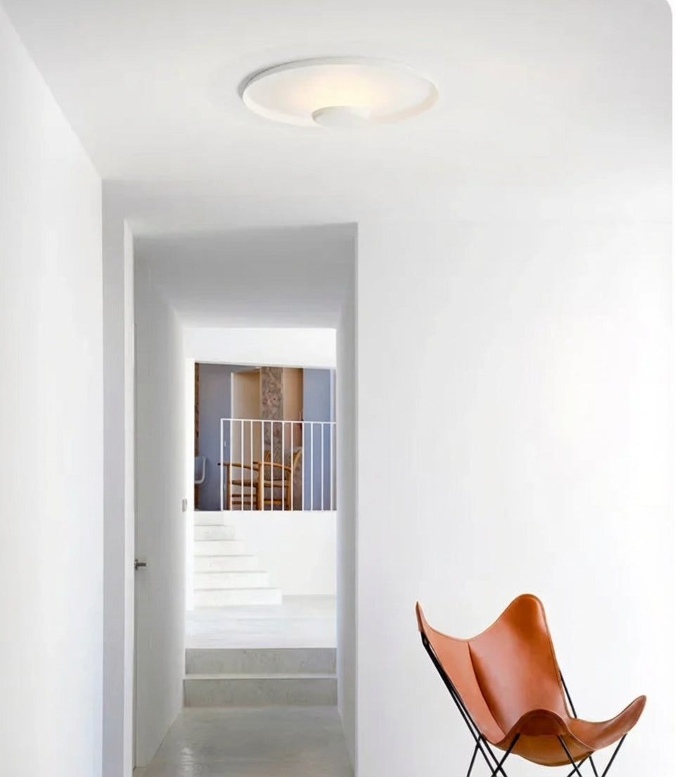 UFO Wall Lighting in white illuminating a bright hallway with soft ambient glow, its low-profile flush-mount design maximising space ,Domus Collective architectural lighting for Australian homes.
