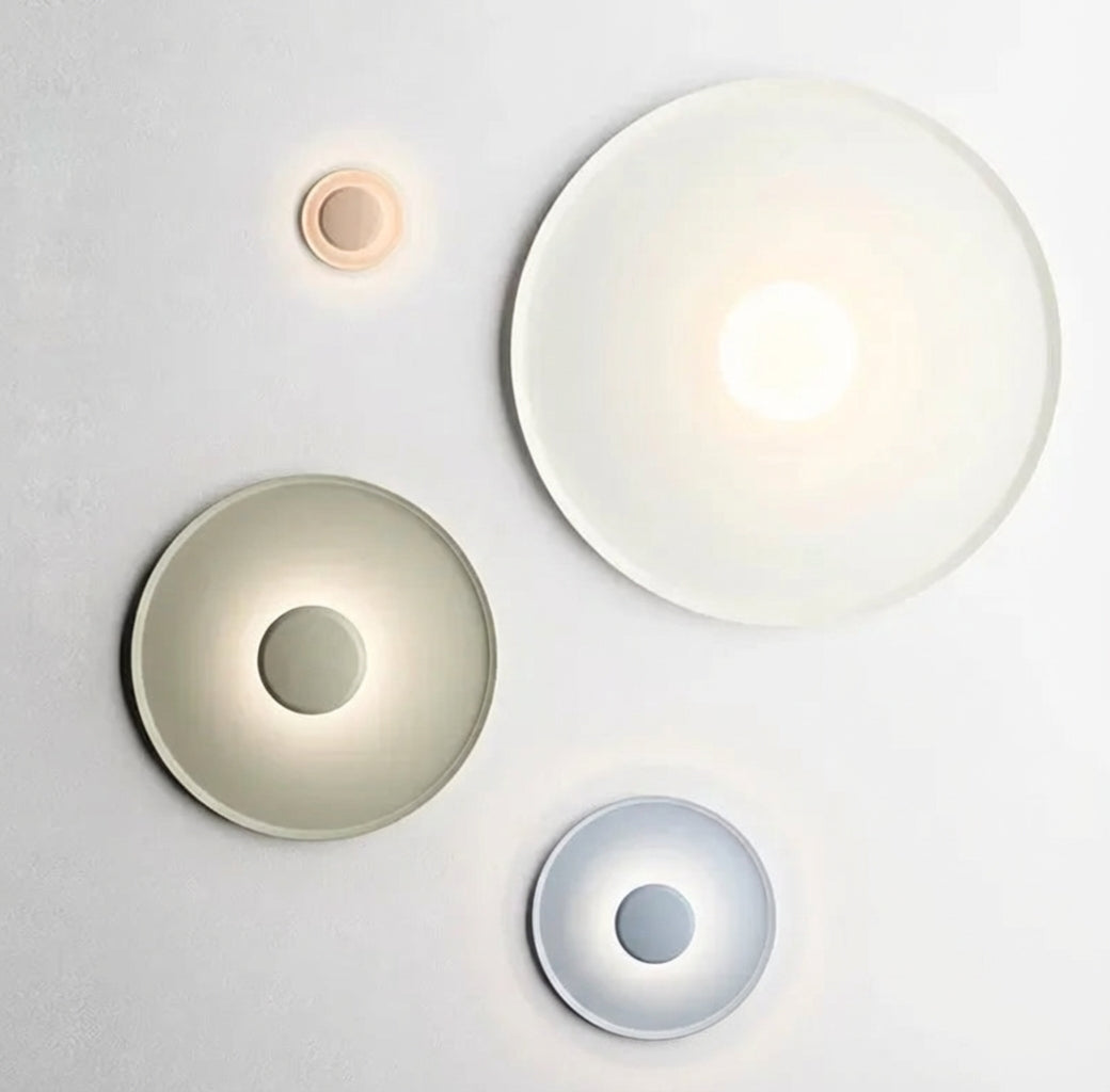 UFO Wall Lighting collection by Domus Collective showing multiple sizes in soft green, white and red finishes with sculptural concave forms creating ambient glow,curated wall lights for contemporary Australian interiors.