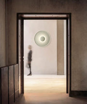 Domus Collective UFO Wall Lighting in green creating a sculptural focal point in an architectural concrete hallway ,timeless wall lamp bringing characterful ambient glow to contemporary Australian interiors.

