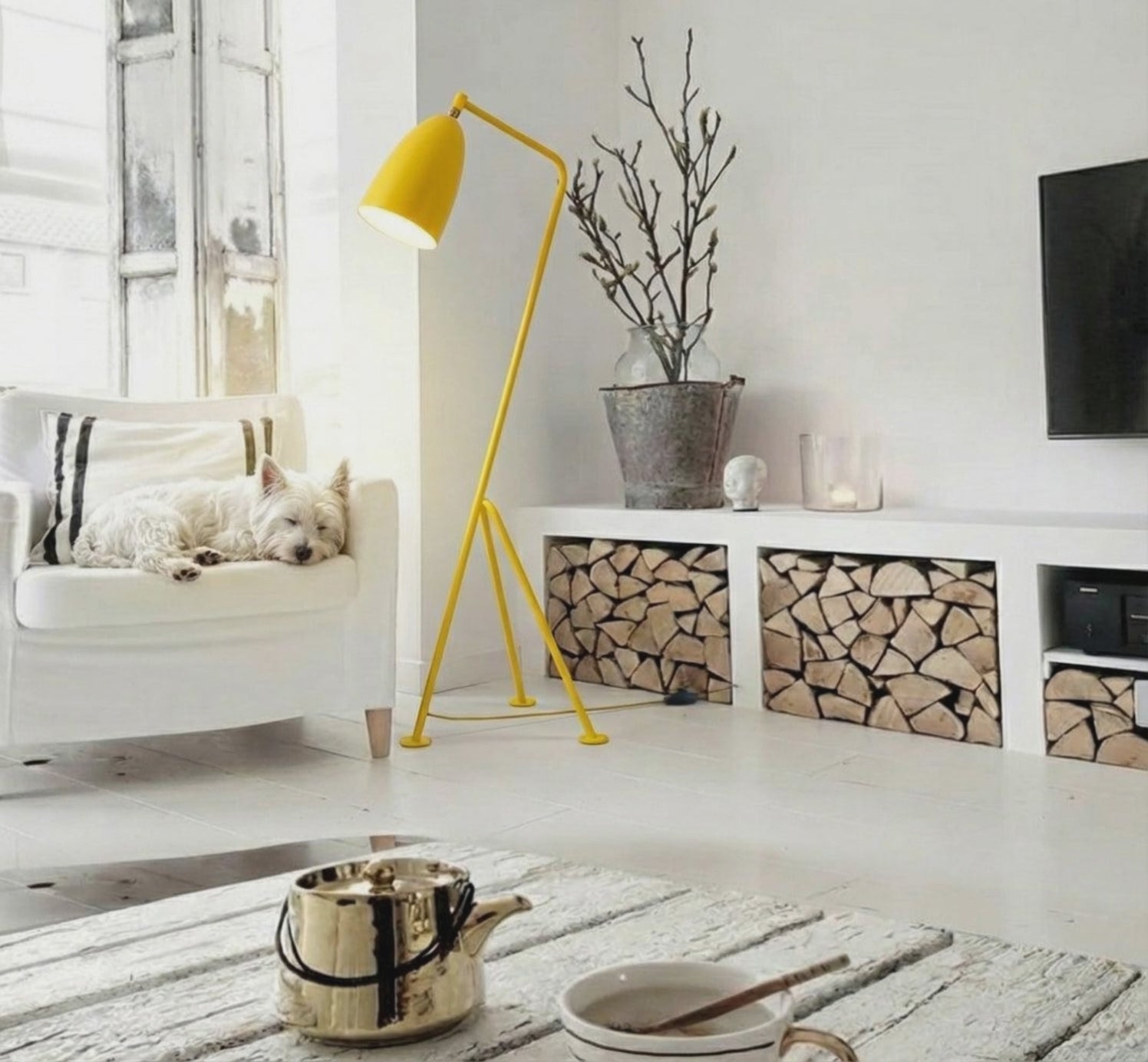 Load video: Flamingo Floor Lamp in vibrant yellow with sculptural tripod base creating warm ambient lighting in a minimalist living room by Domus Collective Colour Me Baby collection, timeless design for Australian interiors.