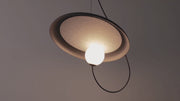 Celestial detail by Domus Collective,The Orbit Floor Lamp close-up showcasing the luminous glass orb nestled within textured disc, soft cosmic illumination with organic paper-inspired materials, timeless Orbit Series craftsmanship.